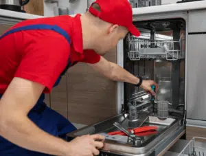 Professional appliance repair technician inspecting appliance estero