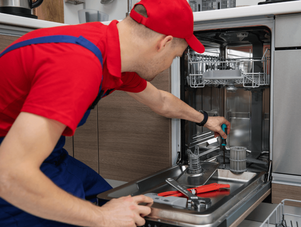 Professional appliance repair technician inspecting appliance.